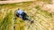 Bird eye of Hay rake tractor turning the hay