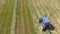 Bird eye of Hay rake tractor turning the hay