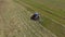 Bird eye of hay rake tractor turning the hay