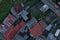 Bird eye view of many tin roofs ranging from orange to grey in a poor neighborhood of a small city in South America