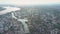 Bird eye view town rooftops and trees near calm blue rivers