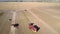 Bird eye view truck drives on potato field past combine