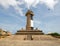 Bird flying past Lighthouse landmark monument at the Galle Face in Colombo Sri Lanka