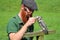 Bird handler feeding small owl on perch