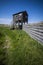 Bird hide under blue sky on nature reserve