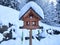 Bird house artfully designed covered with snow in snowy winter scenery