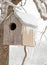 A bird house after an ice storm