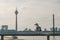 Bird on railing and  defocus background of downtown district, Rhein tower, suspension bridge and Rhine River.