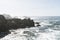 Bird Rock in Point Lobos State Reserve Park in Monterey California on a sunny, yet hazy day. Birds such as pelicans and seagulls