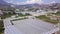 Bird\'s-eye view. Clip.Huge summer mountains with houses and various areas for farms.