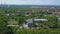 Bird\'s-eye view. Clip. A small village with its own houses and industry, roads and parks and green trees around.