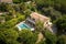 bird's-eye view of elegant mediterranean house, with private swimming pool and lush garden