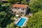 bird's-eye view of elegant mediterranean house, with private swimming pool and lush garden