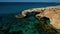 Bird\'s eye view of The Love bridge in the Mediterranean waters in Ayia Napa, Cyprus. Natural rock arch.