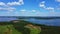 Bird`s eye view overlooking the lake, blue sky and forest.