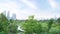 A bird\\\'s-eye view of a park. with trees growing lushly In the middle there is a nice concrete walkway