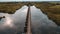 Bird\\\'s eye view shot of the Moerputten Bridge over the scenic lake