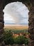 Bird\'s eye through the window of the old castle in view of the Alazani Valley, the clouds in the sky sunset