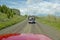 Bird watchers and red jeep in spring grasslands and mountains in Centennial Valley, Lakeview MT