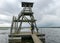 Bird watching tower, man at the tower, cloudy day, gray clouds, landscape with lake, Engure nature park, Latvia