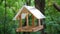 Birdhouse in forest. Bird feeders. House for birds in park. Empty nesting box