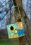 Birdhouse hangs on a tree. Funny and colorful colors