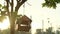 Birdhouse hung on tree. Hand made bird box swinging in wind on sun down, wood bird feeder, starling box. Slow motion