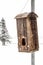 Birdhouse made with old wood. Winter landscape background