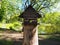 A birdhouse on a tree stump, a wooden feeder for birds
