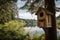 birdhouse with view of peaceful lake, surrounded by tall trees