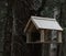 Birdhouse weighs on a branch in the forest