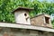 Birdhouse. Wooden house for birds. Birdhouse on a background of green foliage