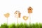 Birdhouses and wooden bird on a background of green grass