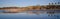 Birds, beachgoers and reflections at low tide during sunset at L