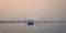 Birds circling around fishing boat at Ganga river vintage effect.
