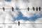 Birds on elecricity wires against blue sky. One bird outside the group. Concept of job vacancy. Business concept