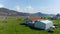 Birds eye drone view over farmhouse in Iceland. Aerial view flying over isolated house in Iceland countryside with