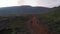 Birds eye orbit small group tourist walking exploring wilderness desert in Iceland. Drone view adventurous hikers