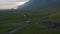 Birds eye orbit view of four by four off road car parked in grassy highland of Iceland. Aerial view rental car parked at