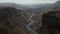 Birds eye stunning and surreal landscape of Haifoss valley in Iceland with river Fossa flowing on riverbed. Aerial view