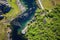 birds-eye view of a clear fishing spot by a meandering river