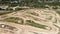 Birds eye view of motocross track. Professional motorbike motorcycle race track with enclosed dirt circuits with steep obstacles