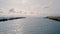 Birds eye view over a river mouth towards the lake in winter season