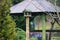 Birds feeder outdoors on a wooden pillar