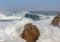 The birds flee from the rock because of a large Atlantic wave.