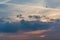 Birds Flying in Cloudy Sky with Crimson Sunrise behind the Alps