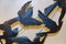 Birds flying in freedom - small detail of metal decor with shadows against wall