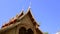 Birds flying out from under temple roof