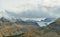 Birds flying over the peaks of the mountains during cloudy day in Canadian Rockies along the Icefields Parkway