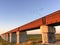 Birds Flying over a Rusty Bridge